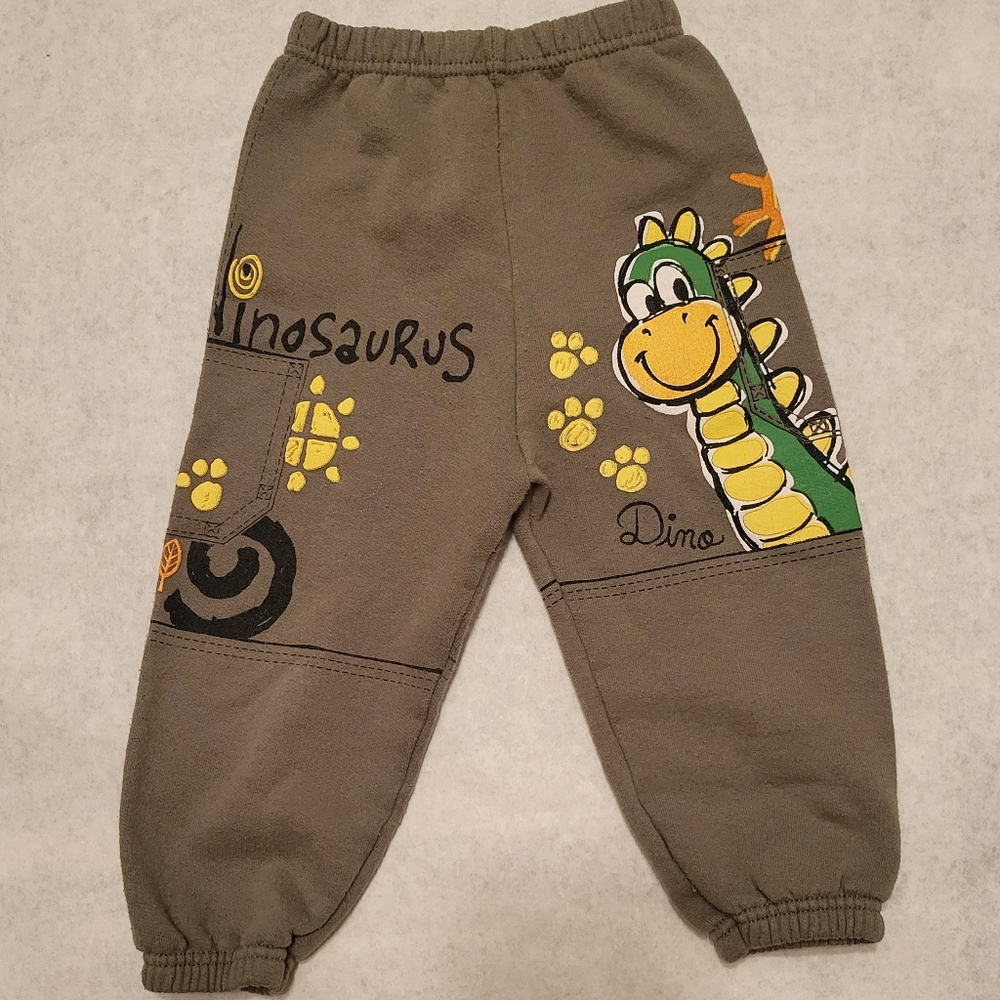 Super cute green joggers/sweatpants with dinosaur graphics